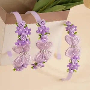 Detailed view of purple floral headband with lace butterfly and pearl accents for girls