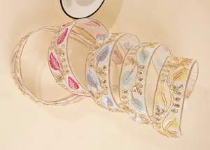 Detailed embroidery on organza headband featuring colorful sequins and gold edges