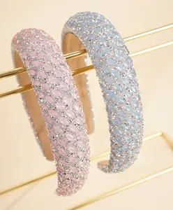 Detail of pink and blue rhinestone sponge headbands on a gold display stand