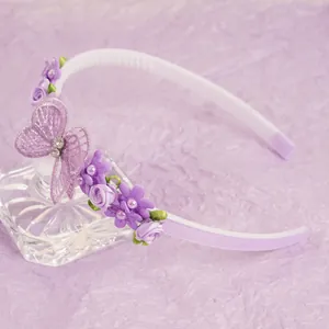 Detail of purple butterfly headband with embroidery, fabric flowers and pearls for girls