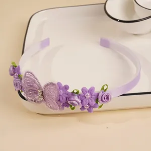 Detailed view of kids purple floral headband with glitter butterfly and satin finish