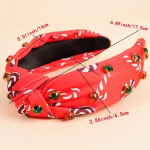 Detail of red candy-themed knot headband with festive crystals and sizing specifications