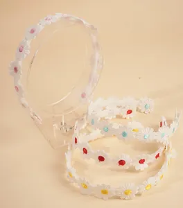 Detailed close-up of four lace headbands with embroidered daisy patterns in various colors