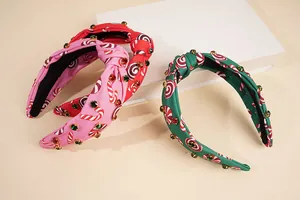 Detail of Christmas knot headbands with rhinestone accents and candy cane prints