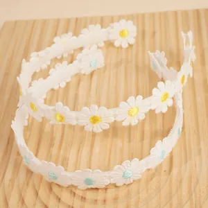 Set of two white daisy embroidered headbands with yellow and blue floral centers