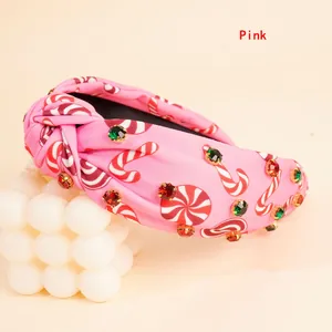 Detail of pink knotted headband with candy patterns and colorful rhinestones decor