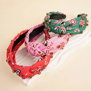 Detail of knotted rhinestone headbands featuring festive candy cane and mint prints