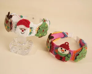Detail of handcrafted crochet Christmas headband with 3D snowman and Santa appliques