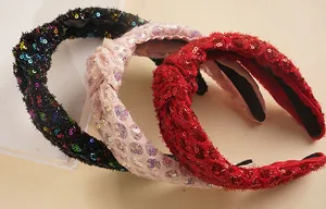 Detail of fabric headbands with sparkling sequins and twisted knot design in three colors