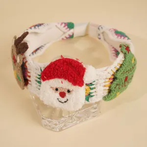 Knitted Christmas headband featuring plush Santa, reindeer and tree on a stand