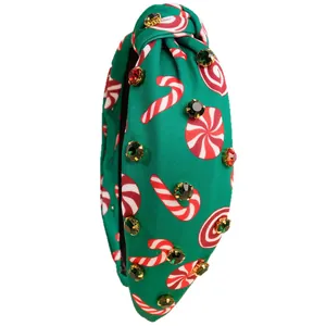Green Christmas knotted headband with rhinestone candy cane print in 45-degree view