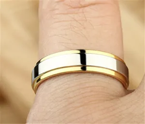 Macro detail of a two-tone tungsten ring with gold edges and silver mirror finish