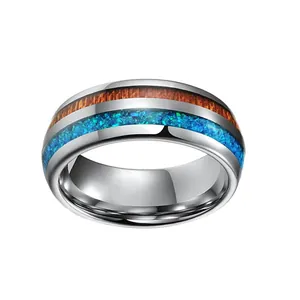 Polished tungsten carbide ring with wood grain and blue crushed opal inlay