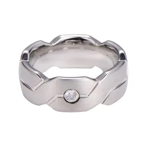 Brushed silver tungsten ring with geometric tiered design and centered crystal inlay
