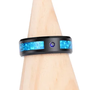 Detail of black tungsten ring with blue opal inlay and sparkling blue diamond center