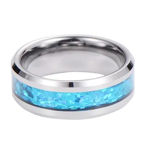 Macro shot of silver tungsten ring with blue opal inlay and polished beveled edges