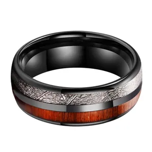 Men's black tungsten ring featuring meteorite texture inlay and natural wood grain
