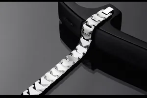 Detail shot of silver tungsten steel bracelet with geometric links on a black stand
