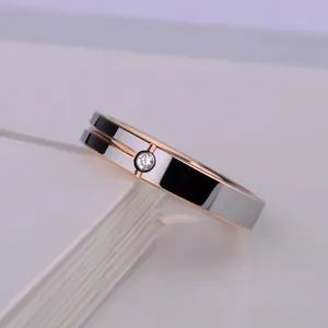 Polished two-tone rose gold and silver tungsten steel ring with a center diamond stone