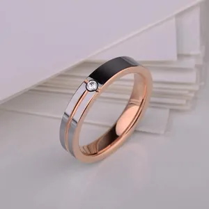 Macro shot of rose gold tungsten ring with silver inlay and sparkling center zircon detail
