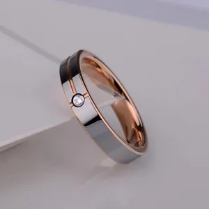 Minimalist tungsten ring in silver and rose gold with a sparkling center diamond