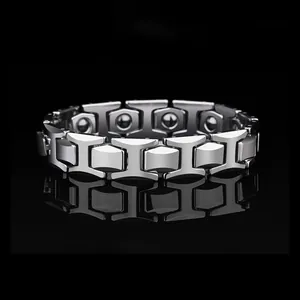 Polished tungsten steel bracelet for men with magnetic therapy beads on black background