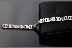 Macro detail of silver tungsten steel bracelet with black magnetic stones and folding clasp