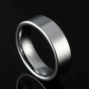 Polished silver tungsten carbide ring for men with mirror finish on black background