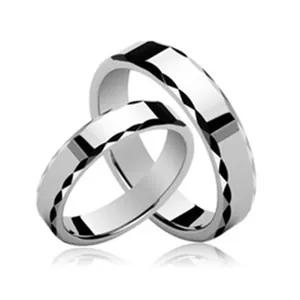 Polished tungsten couple rings featuring a unique geometric diamond-cut design