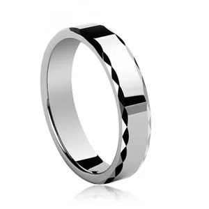 Modern silver tungsten ring with geometric faceted cuts and polished surface on white base