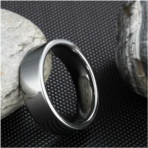 Polished silver tungsten steel ring with a minimalist mirror finish on a stone background