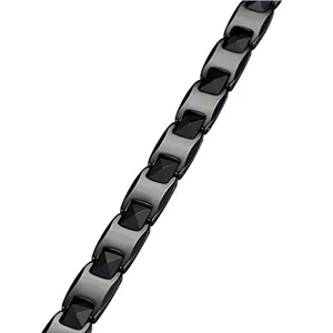 Men's tungsten link bracelet with black geometric pyramid studs on white background