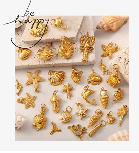Macro detail of golden sea life charms including starfish and shells with pearls