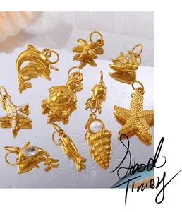 Macro shot of gold ocean pendants with pearls and zircons on a reflective water surface