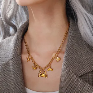 Golden ocean theme necklace with starfish and crab charms on a female model