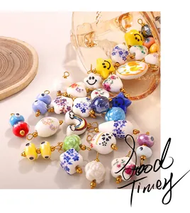 Detailed macro view of assorted ceramic charms including stars and hearts for DIY jewelry