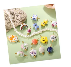 Close-up of colorful ceramic star charms and pearl necklace on a soft green background