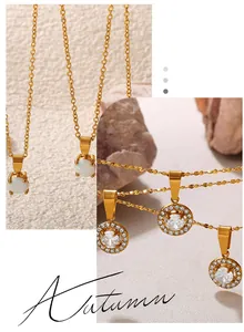 Detail of 18K gold plated necklaces with opal and cubic zirconia stone pendants