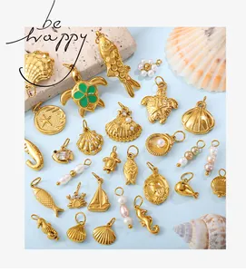 Detailed view of various golden ocean-themed DIY jewelry charms with pearls and starfish