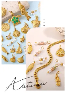 Detailed macro of gold ocean charms with faux pearls and enamel on a thick chain