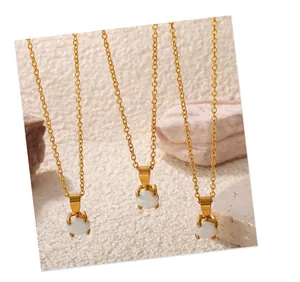 Detailed macro view of three 18K gold plated necklaces featuring round opal pendants