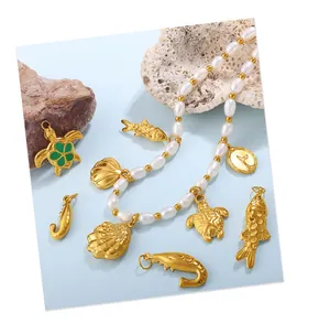 Detail of baroque pearl necklace with golden sea turtle and whale tail ocean pendants
