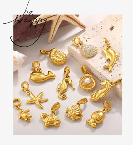 Detailed macro view of 18K gold plated ocean-themed charms with pearls and zircons