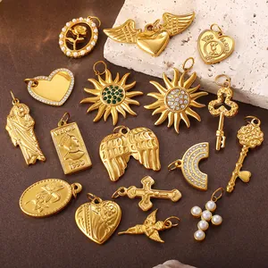 Selection of vintage gold plated pendants featuring hearts, sunbursts, and portrait charms