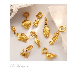 Close-up of 8 ocean themed 18K gold plated charms with spring clasps and rhinestones