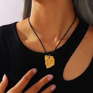 Pendentif vintage doré avec portrait et zircon sur cordon noir porté par un modèle