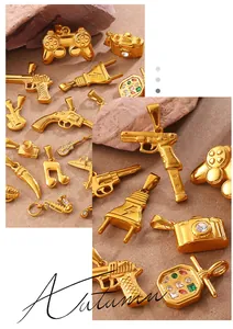 Close-up of gold hip-hop charms featuring a camera, guitar and game controller on rocks