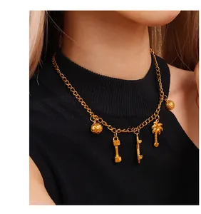 Close-up of golden sports charms necklace featuring football, dumbbell and skateboard pendants
