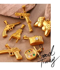 Detailed view of vintage gold metal charms including camera, gamepad, and gun shapes