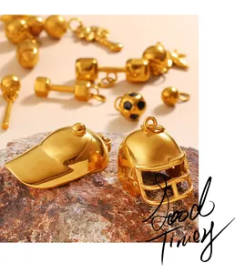 Detailed macro view of gold-plated sports charms including helmets and footballs